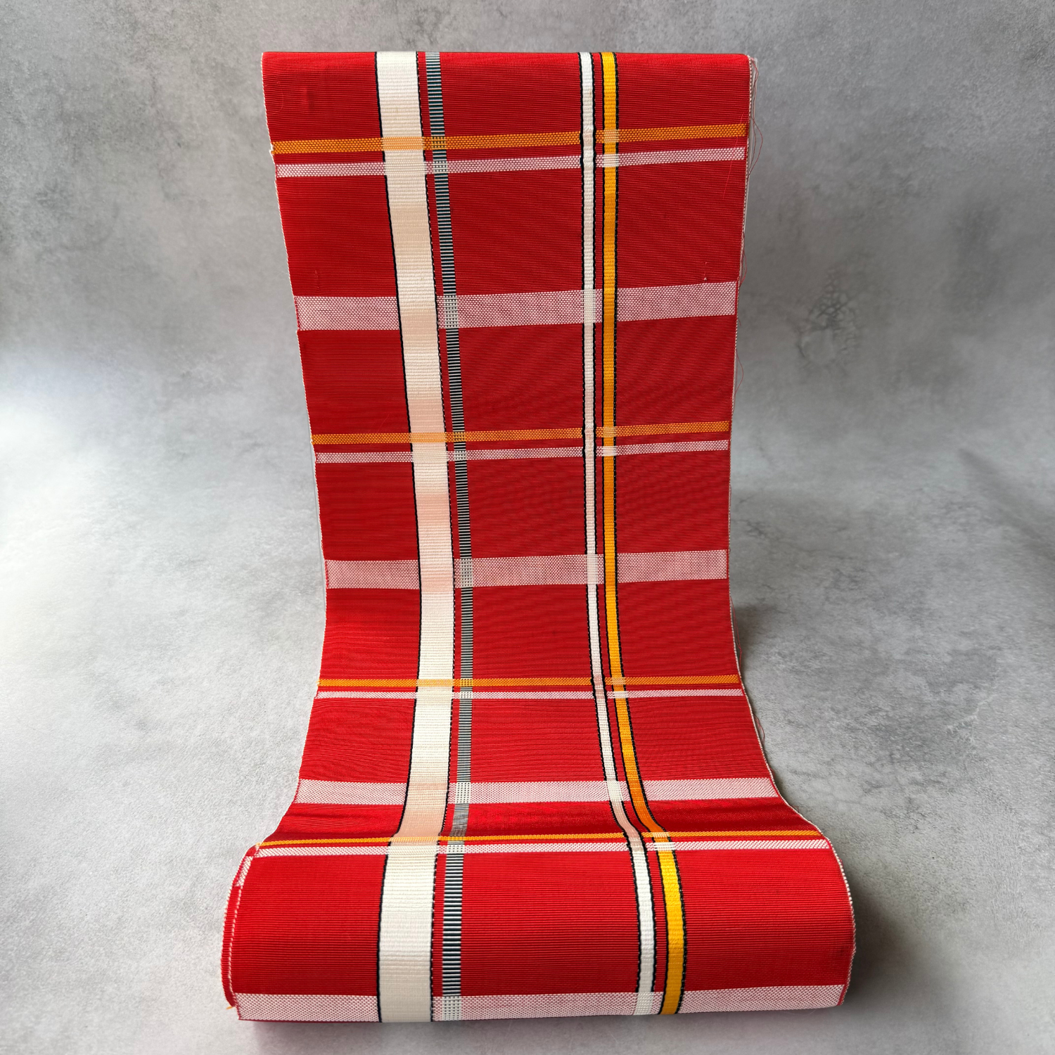 Pre-owned Japanese red plaid obi fabric bolt shown unrolled