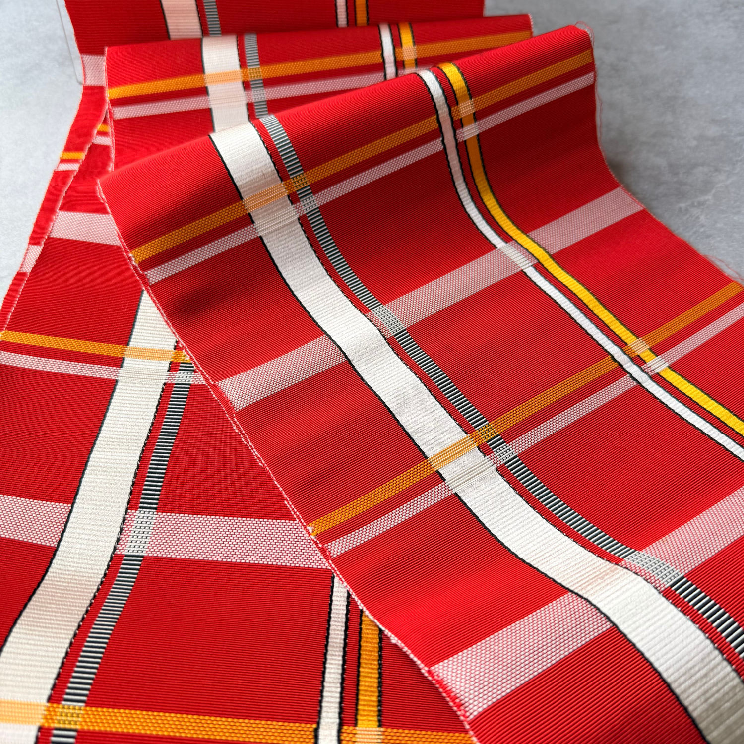 Close-up of plaid grid pattern on Japanese red obi fabric