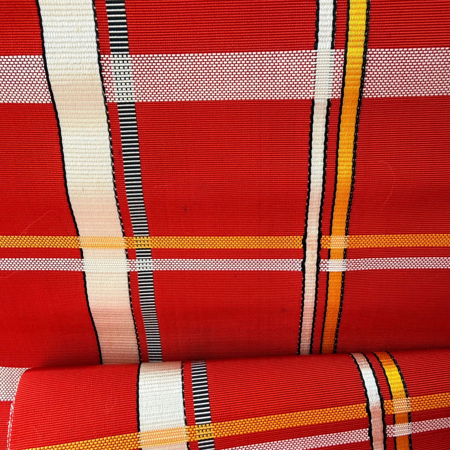 Detailed woven stripe texture of red rayon obi textile